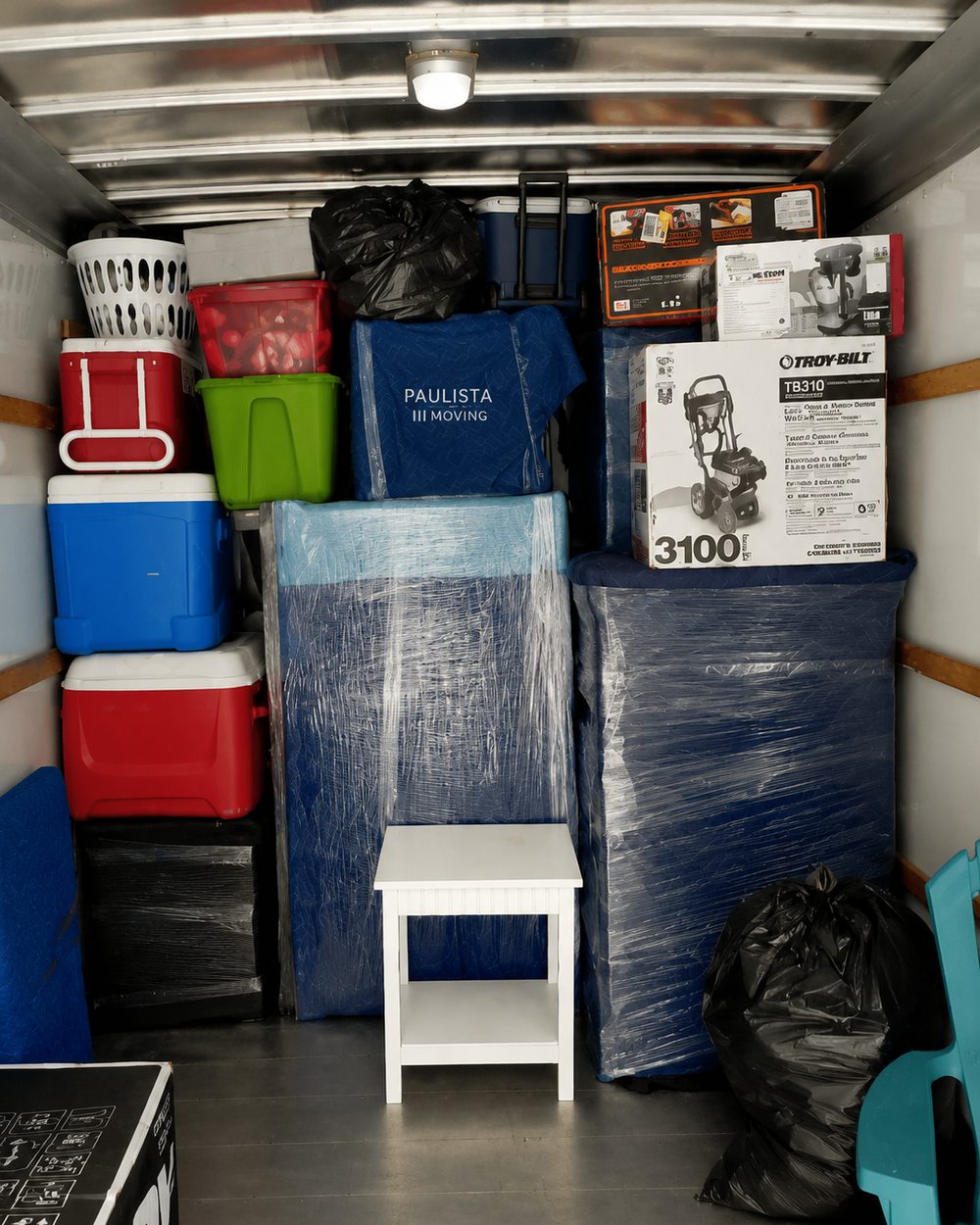Interior of Paulista Moving truck loaded with furniture protected in custom branded moving blankets